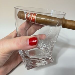Crystal whiskey glass with an indentation to hold a cigar